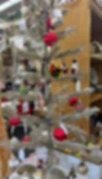 Vintage Christmas ornaments hanging on silver tinsel tree