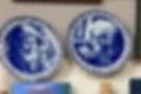 Blue and white portrait plates on wall