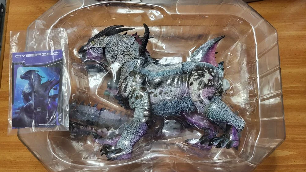 The first plastic tray with the figure, and with the Zoic TCG card and instructions off to the left.